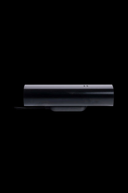 Sleek black cannabis vaporizer pen on charging base.
