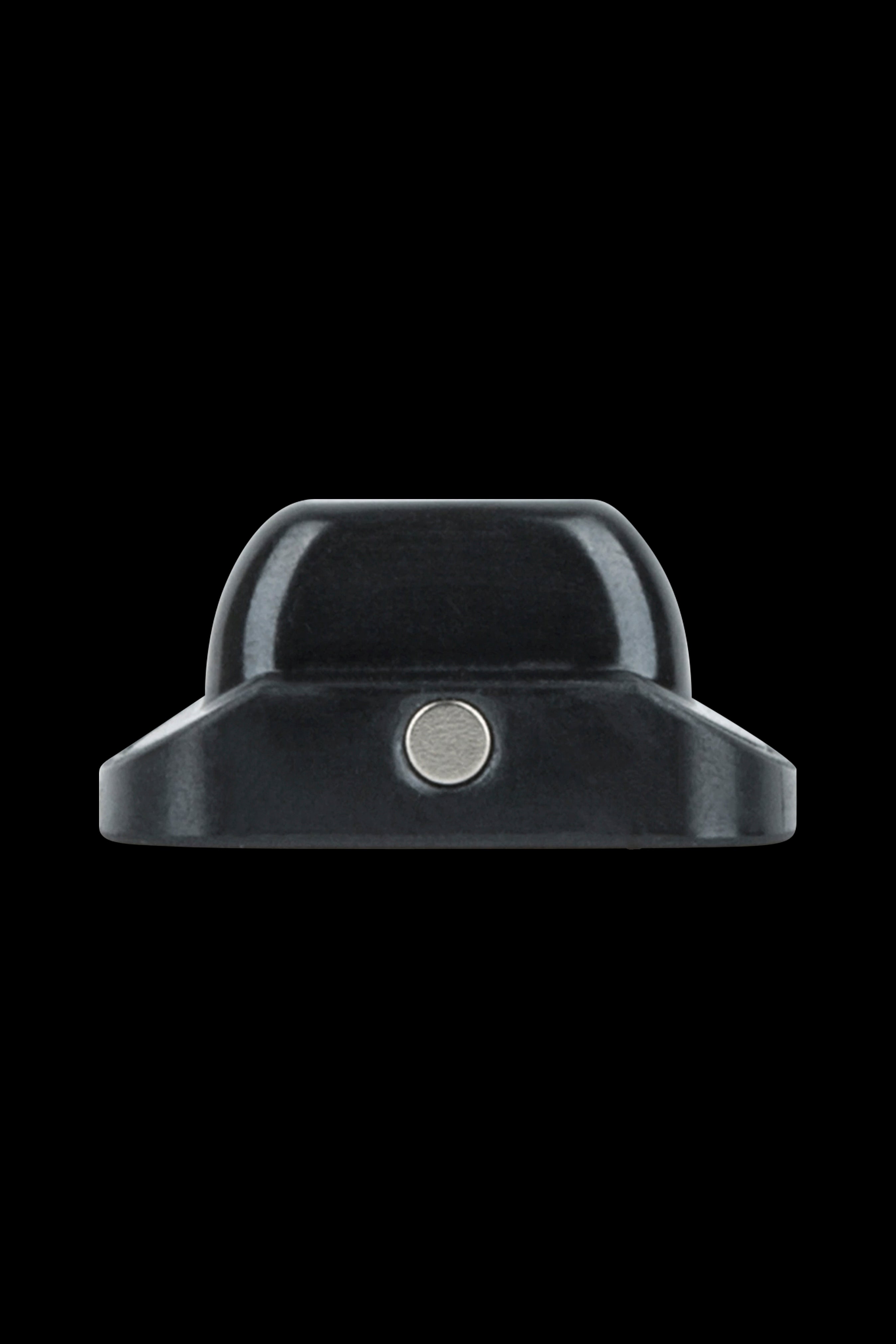 Black cannabis concentrate container with central magnetic button.