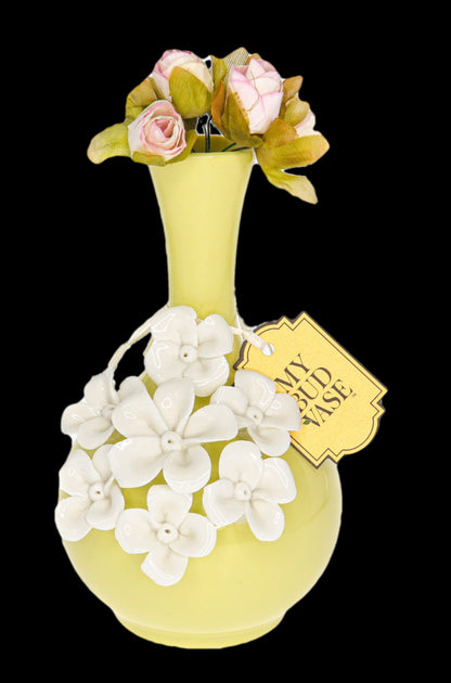 Yellow glass cannabis water pipe decorated with white floral accents and a tag reading “My Bud Vase.”