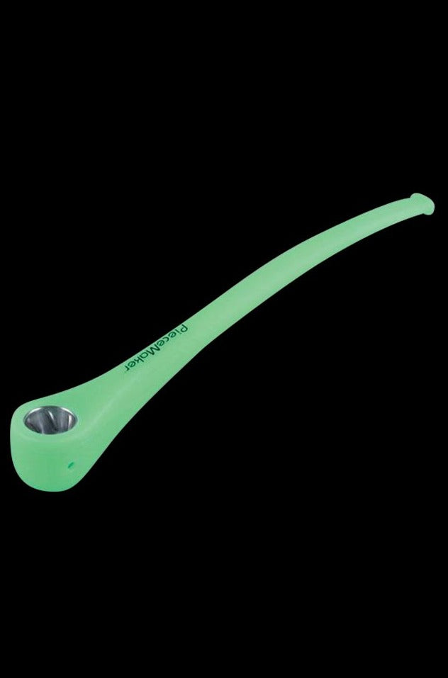 A slightly angled view of the PieceMaker Konjurer silicone pipe, showcasing its curved design and smooth, dark surface.