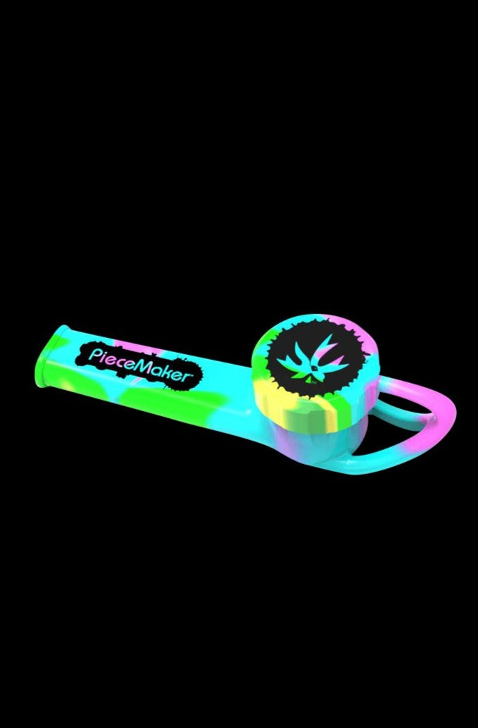 A side view of the Piecemaker Karma Go Silicone Pipe, showcasing its curved design and vibrant color against a black background.