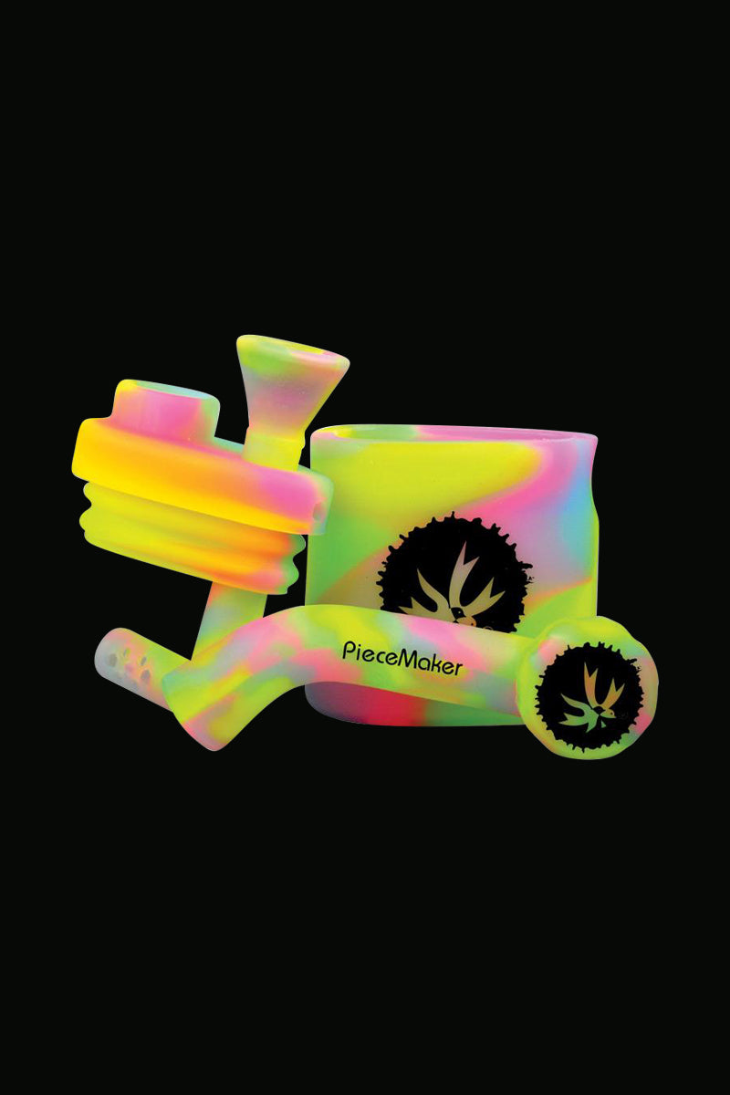 A close-up, angled view of the Piecemaker "Klutch" Silicone Water Pipe, showcasing its smooth, colorful form against a dark backdrop.