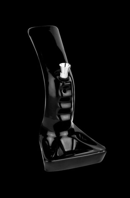 A studio shot of the Pistol Grip Ceramic Water Pipe with Ashtray Base, showcasing its sleek, black ceramic design from a low angle.