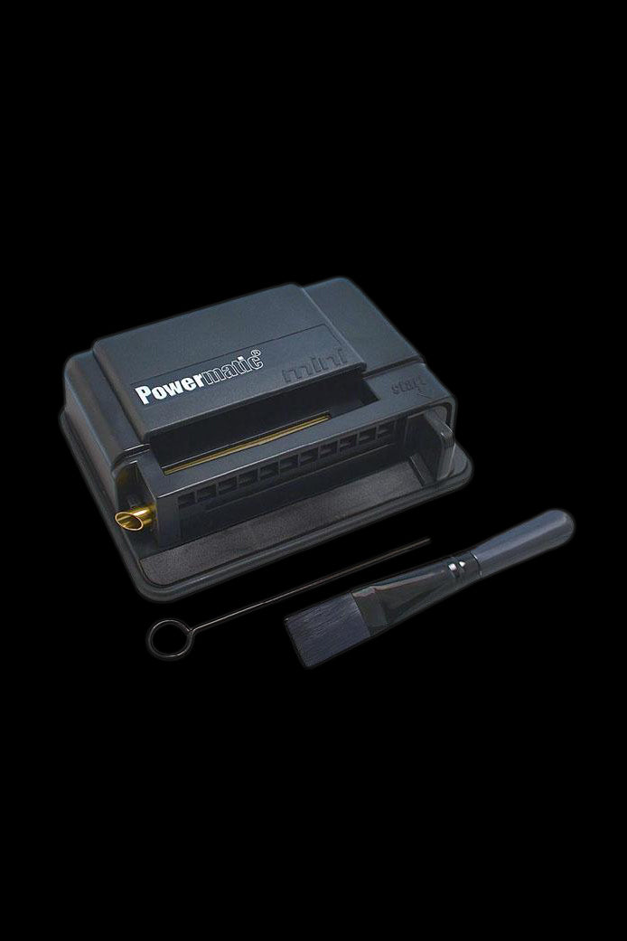Black Powermatic cigarette rolling machine with open tray and cleaning tool.