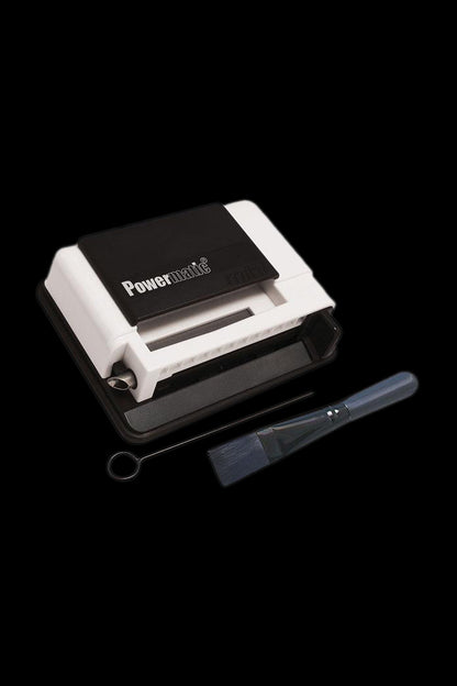 Powermatic cigarette rolling machine with cleaning brush.
