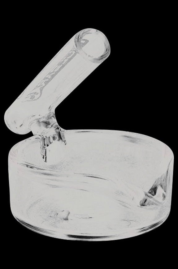 A close-up, angled view of the Pulsar Concentrate Dish with Dabber Holder, showcasing its clear glass construction and integrated tool rest.