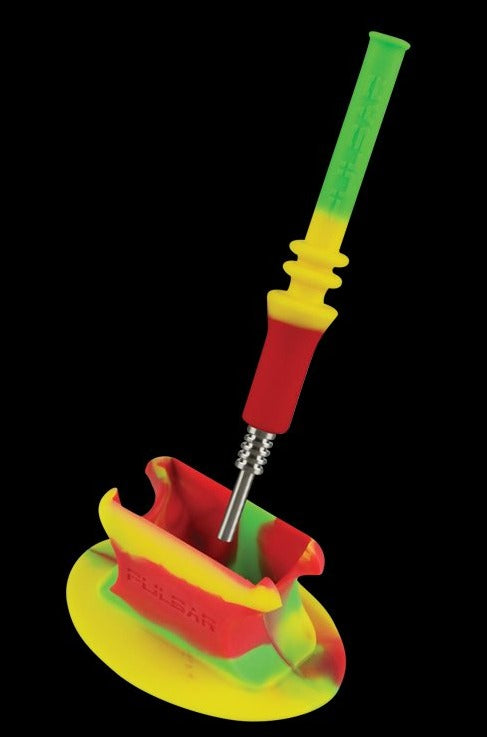 A close-up shows the Pulsar RIP Vapor Straw with Stand - Rasta, featuring a colorful, angled straw resting in its matching stand.