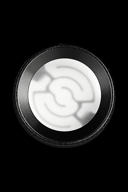 Close-up of a white cannabis concentrate inside a black container.