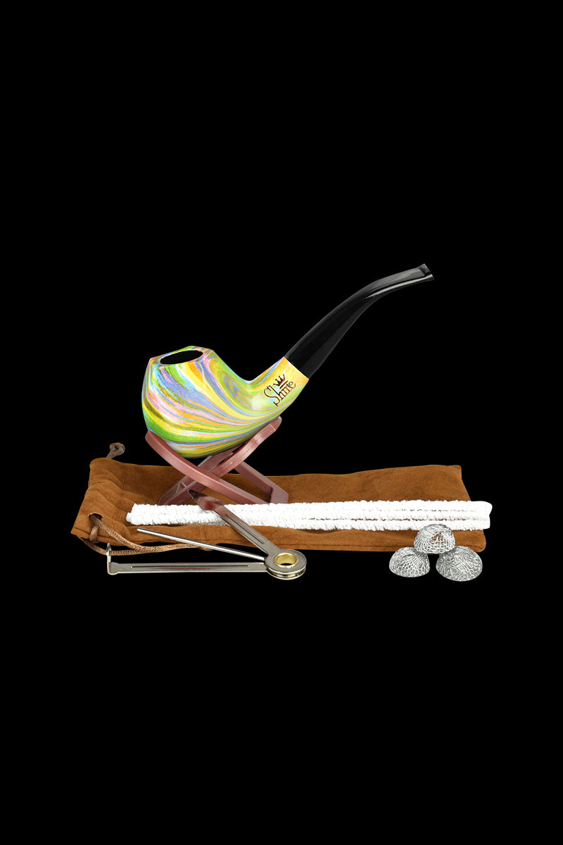 A close-up of the Pulsar Shire Pipes Bent Brandy Rainbow Tobacco Pipe resting on a white surface, showing its colorful, curved design.