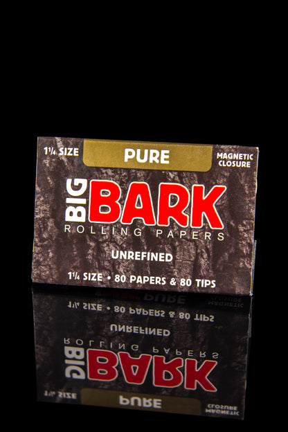 Pack of “Big Bark” rolling papers and tips against a dark background.