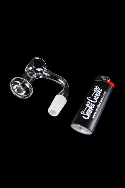 Quartz dab rig with a branded lighter on a black background.