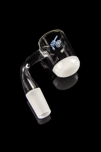 Clear glass dab rig with visible concentrate residue, isolated on a black background.