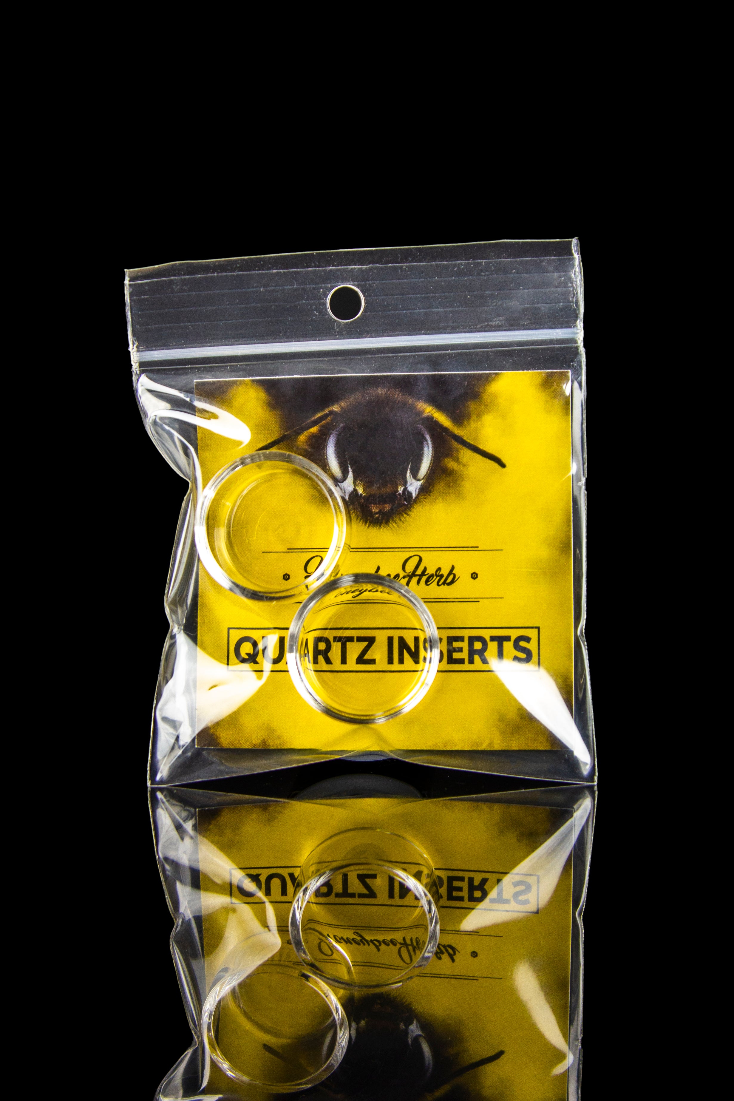 Yellow plastic bag labeled "Quartz Inserts" with a bee illustration, containing a curved, gold-colored quartz insert for dabbing cannabis concentrates.
