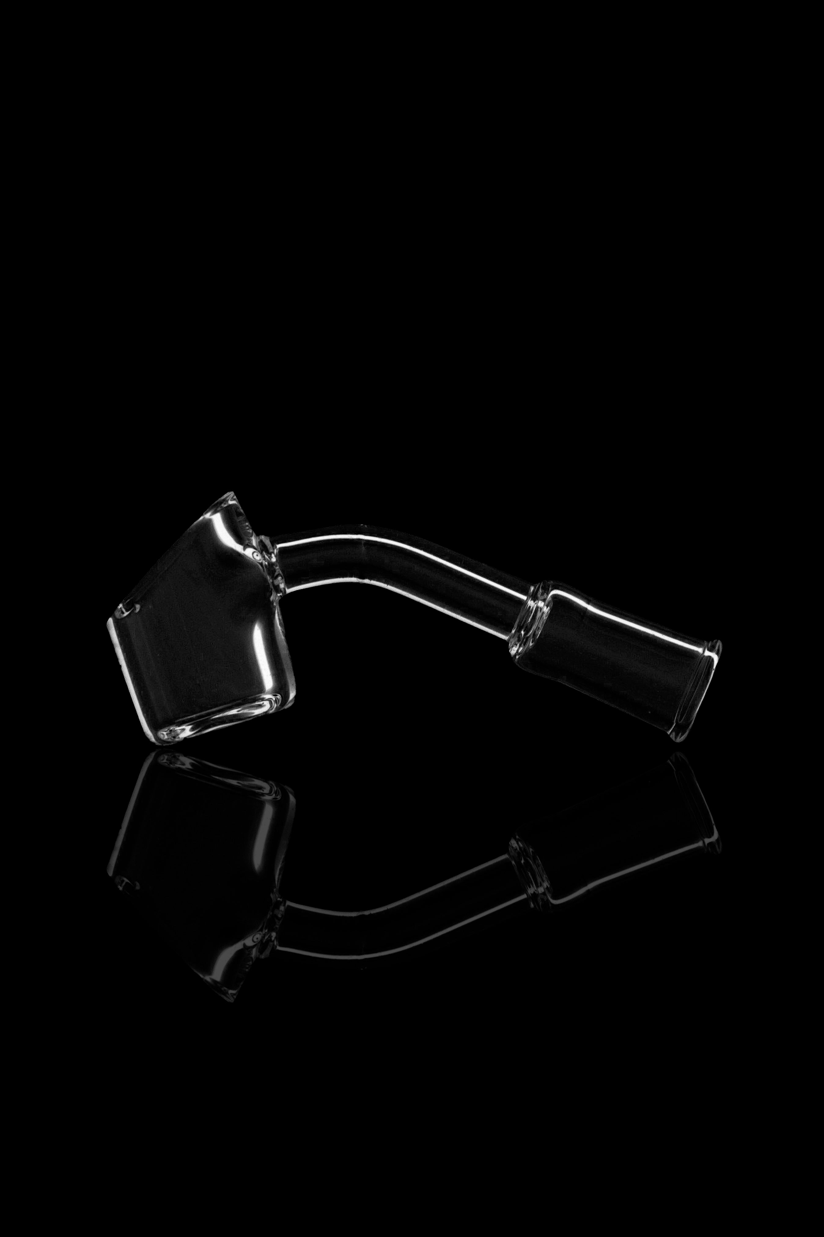 Clear glass cannabis oil rig with a bent neck and angled bowl, reflecting on a black surface.