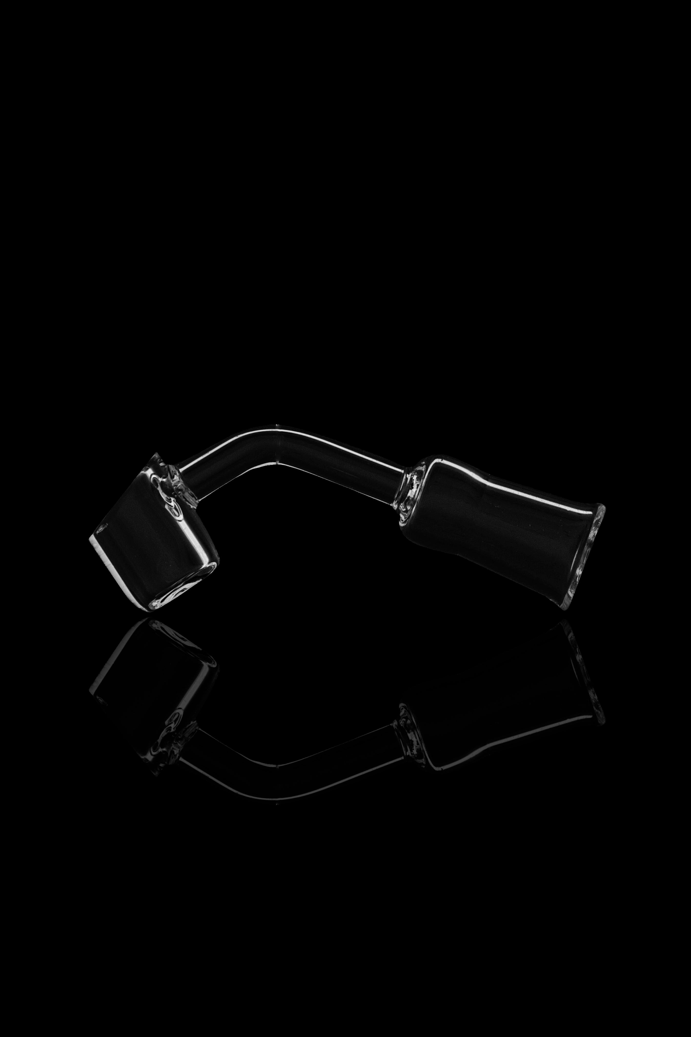 Black glass oil rig with intricate curves against a black background.