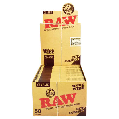 A slightly angled, close-up shot of the “RAW “Cut Corners” Single Wide Rolling Papers” packaging, displaying the brand logo and product name on a white box.