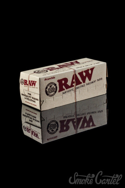 A close-up shot of the RAW Parchment Paper packaging, featuring bold text and graphics against a stark white background.