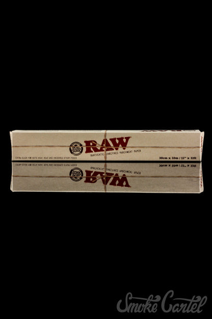 RAW Parchment Paper rests on a dark surface, photographed from a slightly elevated angle with simple, clean composition.