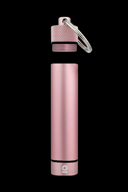 Rosé gold cannabis oil applicator with keychain attached, displayed against a black background.