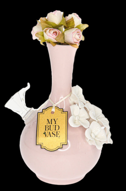 Pink glass water pipe decorated with artificial roses and labeled “My Bud Vase.”