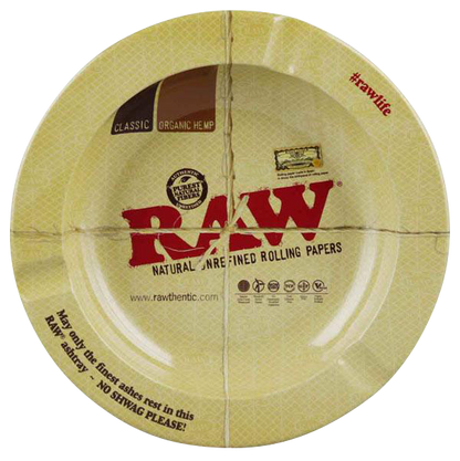 Overhead shot of the RAW Round Metal Magnetic Ashtray featuring branding and text on its circular surface.