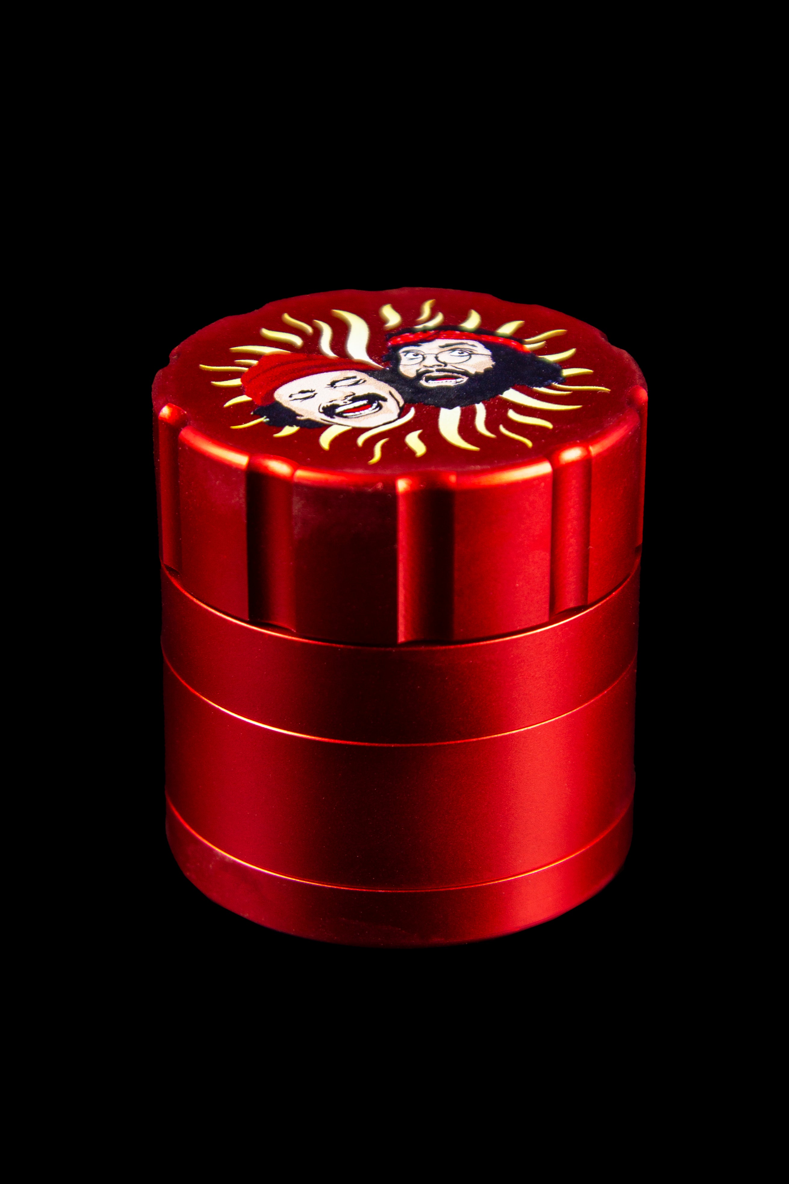 Red four-piece cannabis grinder with Día de Muertos-style skull design.