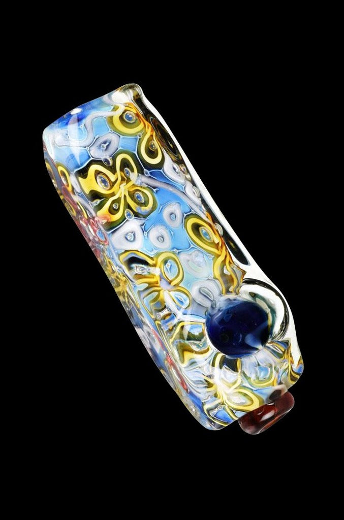 A three-quarter view of the River Flowers Squared Glass Hand Pipe, showing colorful floral patterns on the clear glass.