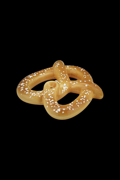 Front view of the Roast & Toast Hot & Salty Pretzel Pipe, a tan-colored, looped smoking device against a plain white background.