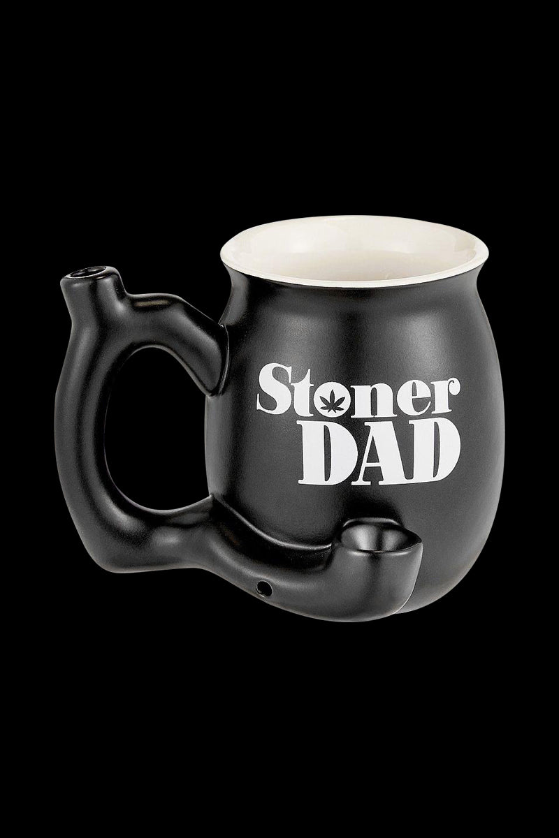 A close-up, angled view of the “Roast & Toast “Stoner Dad” Ceramic Pipe Mug”, showcasing its ceramic construction and mug-like form.