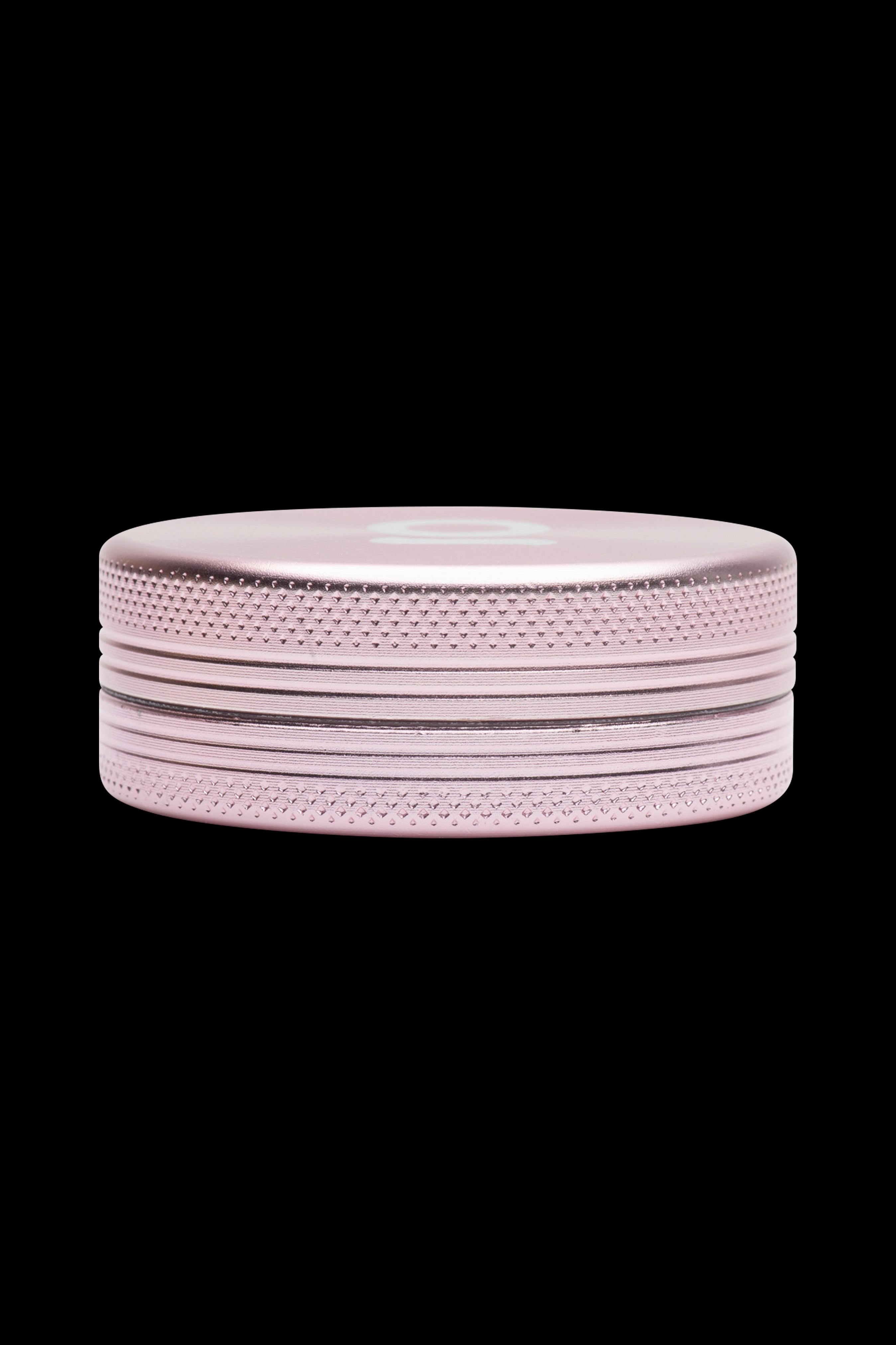 Rose gold cannabis grinder on a black background.