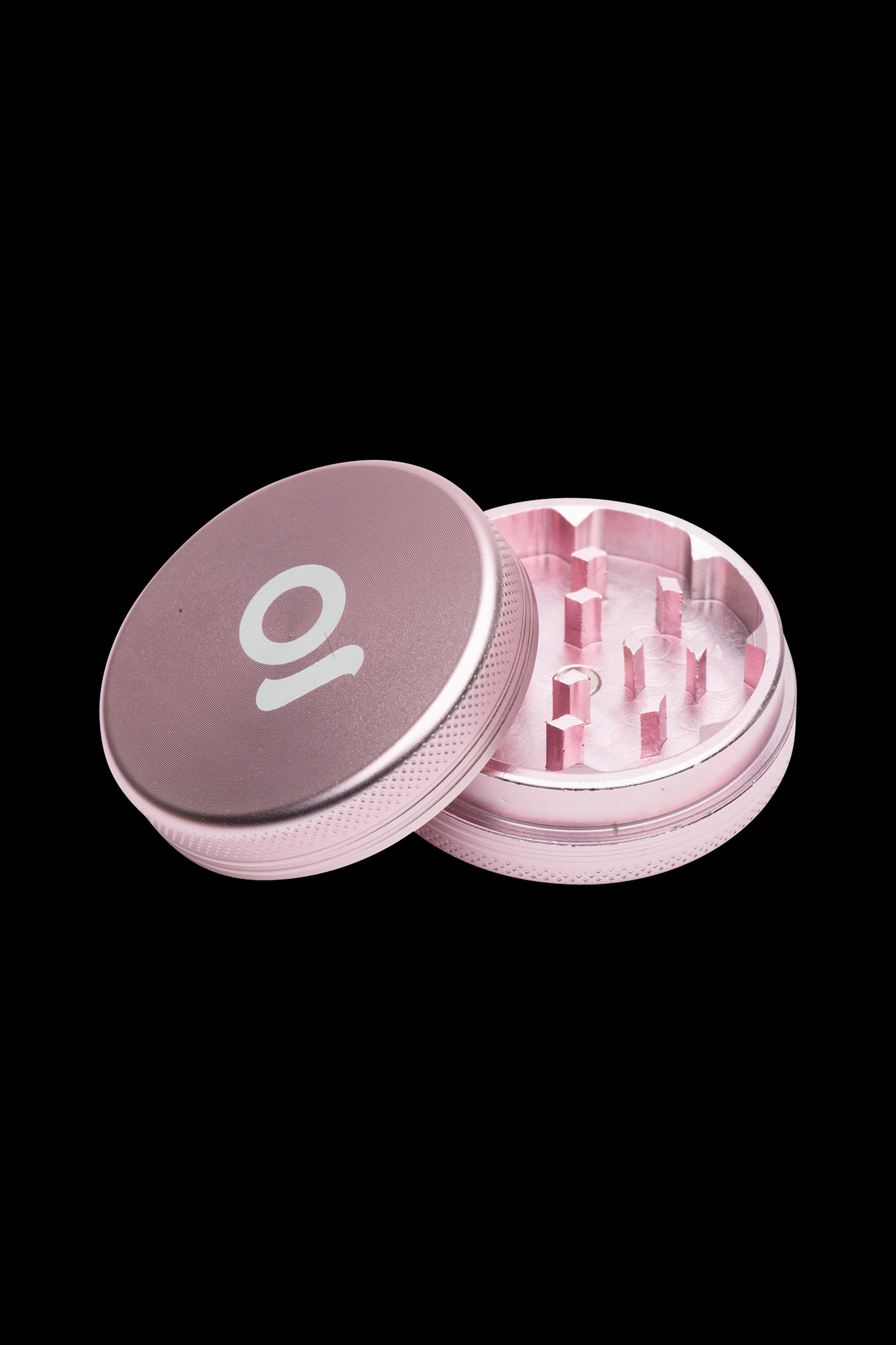 Rose gold cannabis grinder with open lid revealing teeth and chamber.