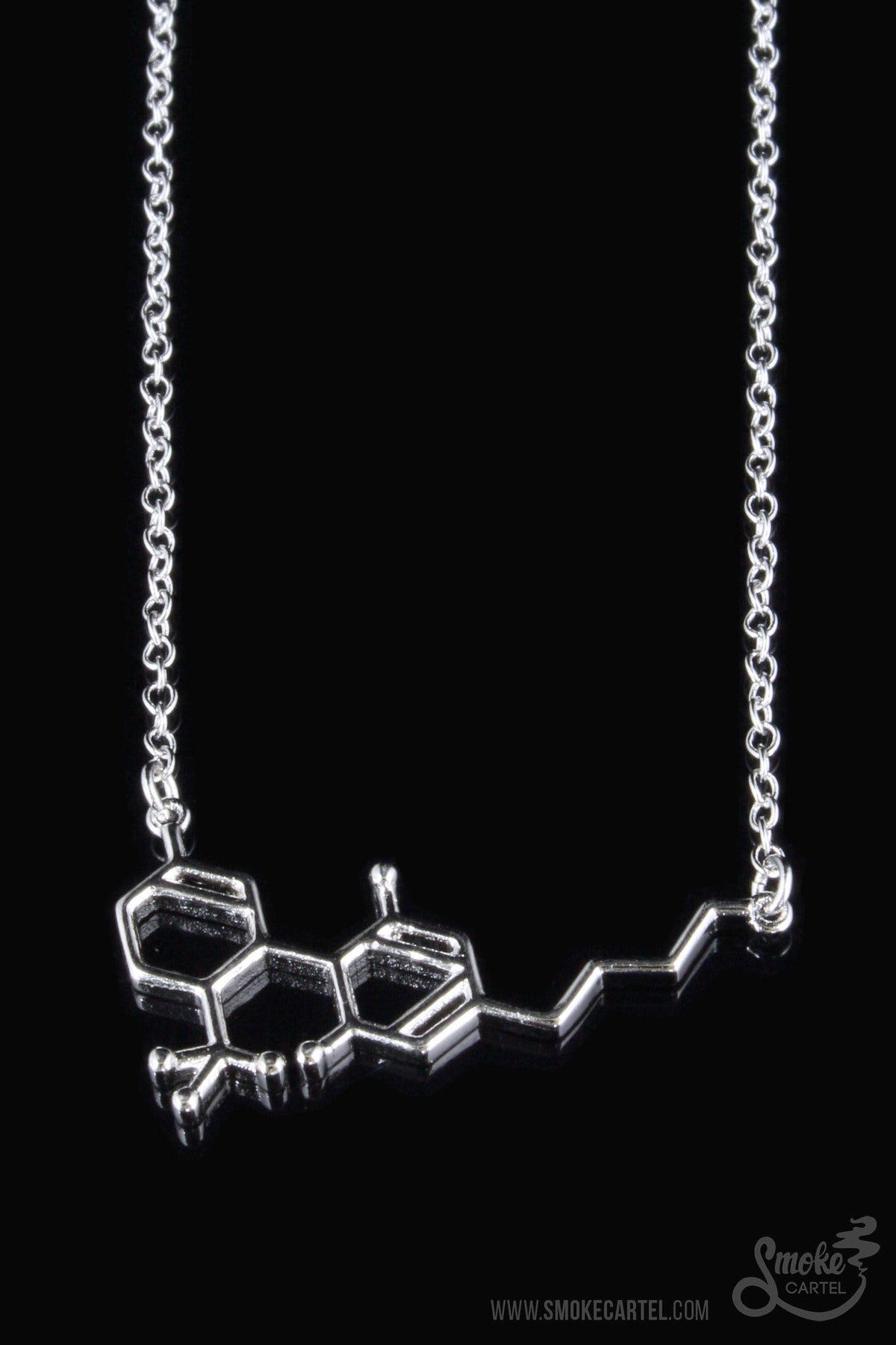A close-up of the Smoke Cartel THC Molecule Necklace, a silver pendant resembling a molecular structure on a delicate chain.