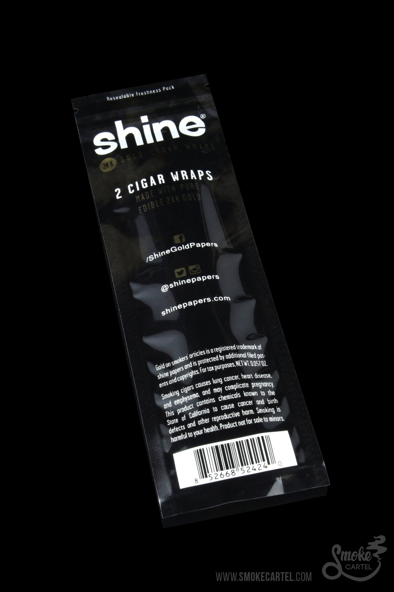 A close-up of Shine 24k Gold Cigar Wraps packaging featuring gold lettering against a black background.