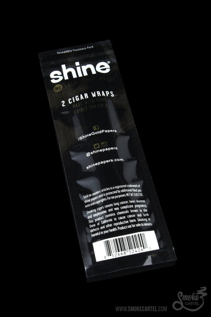 A close-up of Shine 24k Gold Cigar Wraps packaging featuring gold lettering against a black background.