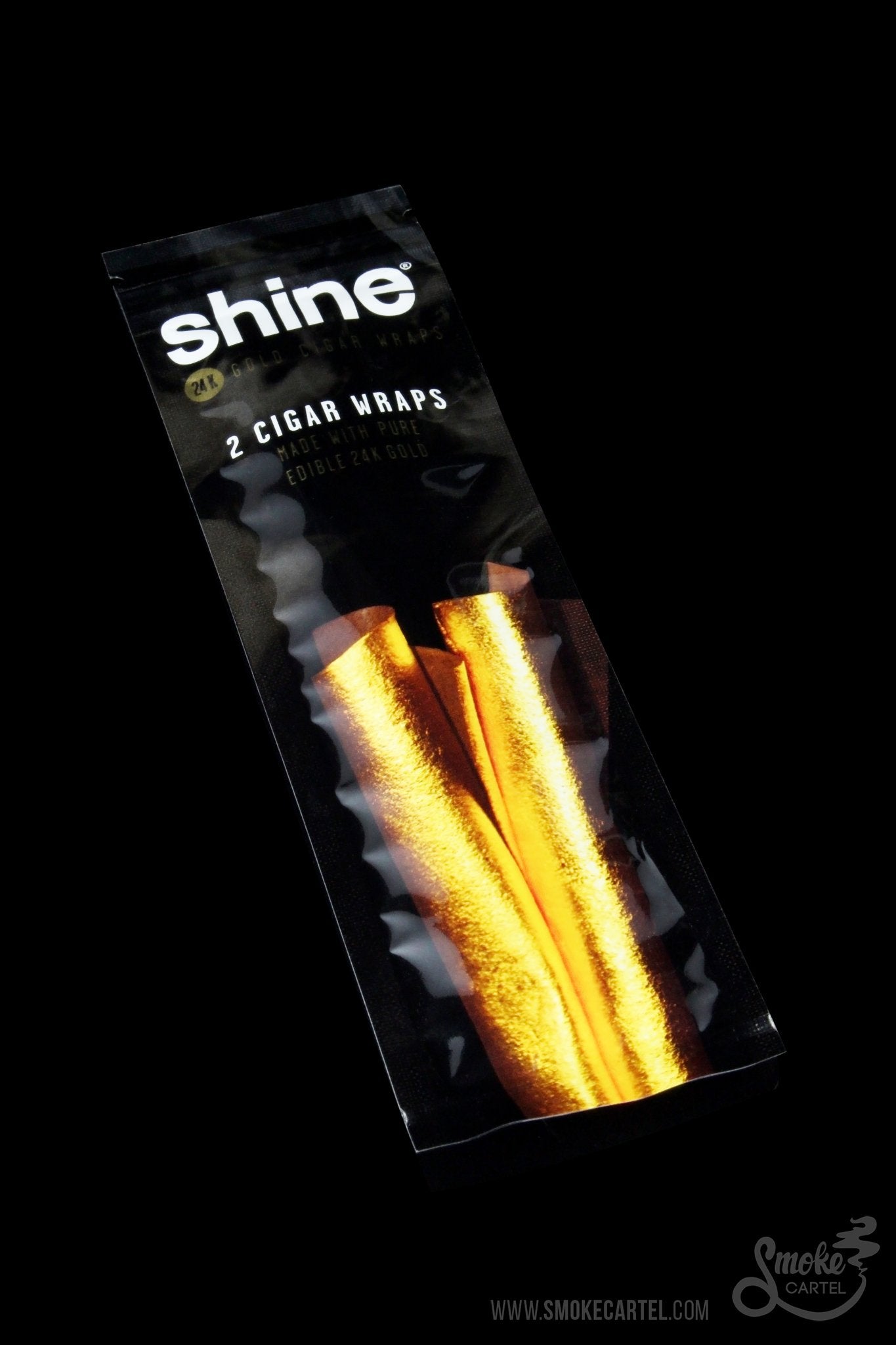 A close-up, angled shot of Shine 24k Gold Cigar Wraps packaging against a dark backdrop, displaying the brand logo and product name.