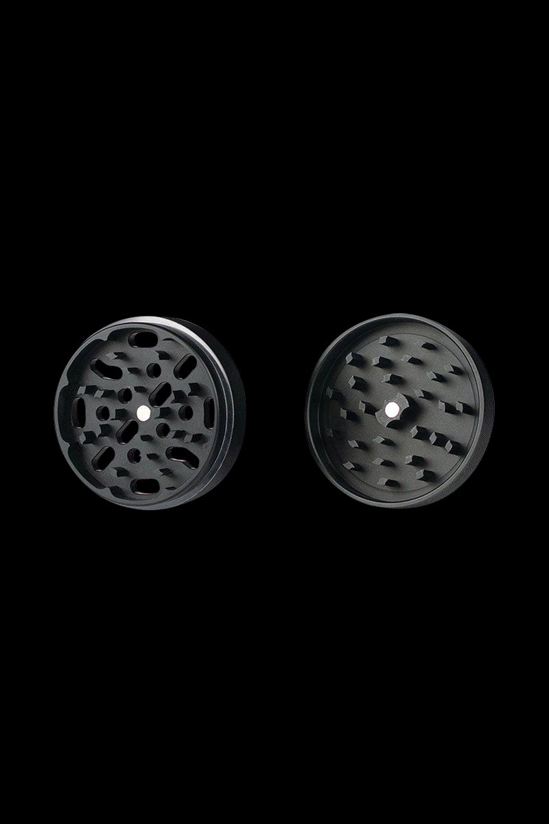 A close-up, top-down view of the Kannastor 4-Piece Solid Body Grinder showcasing its textured metallic finish and circular design.