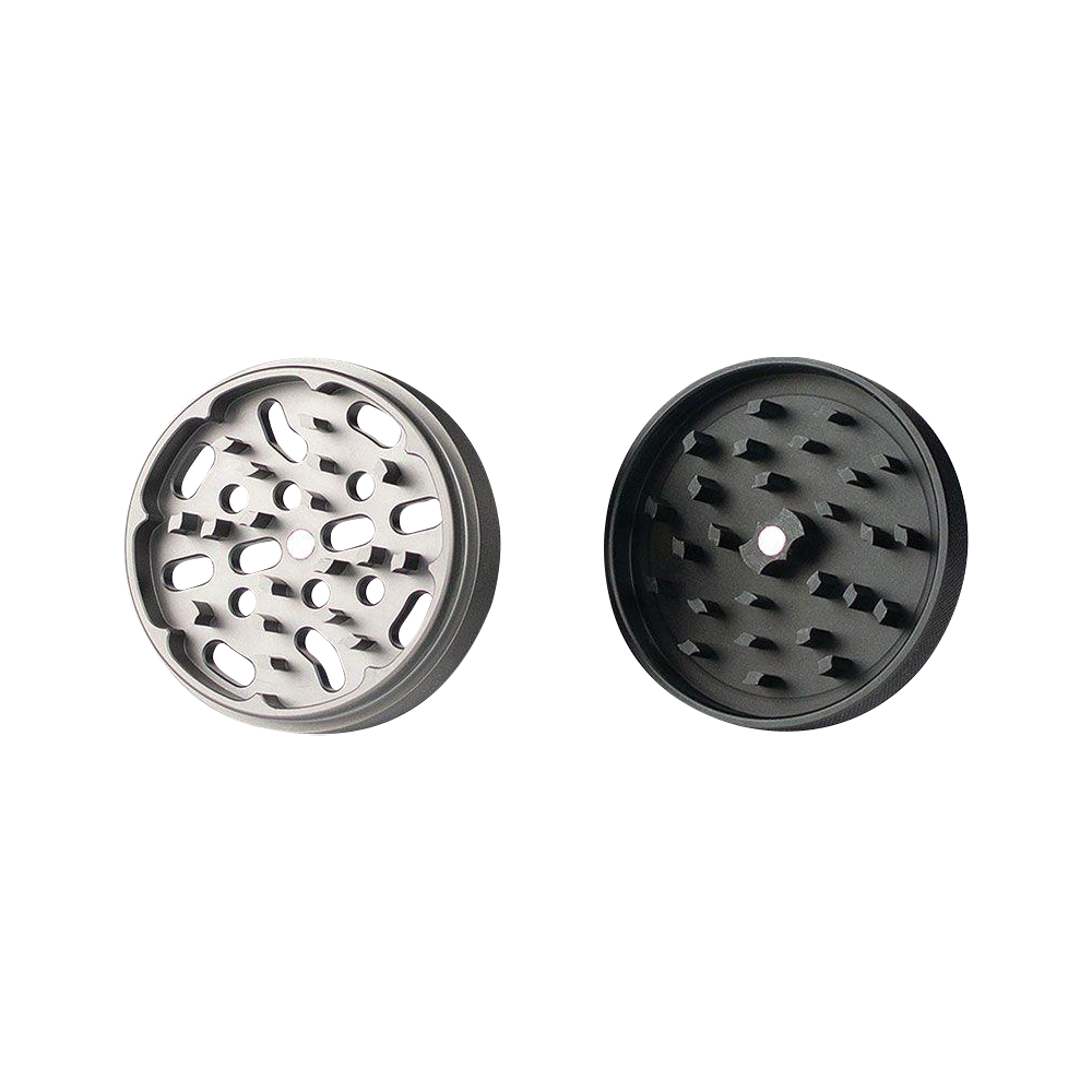 A top-down view of the open Kannastor 4-Piece Solid Body Grinder, showcasing the multi-tiered grinding chamber with sharp metallic teeth.