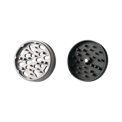 A top-down view of the open Kannastor 4-Piece Solid Body Grinder, showcasing the multi-tiered grinding chamber with sharp metallic teeth.