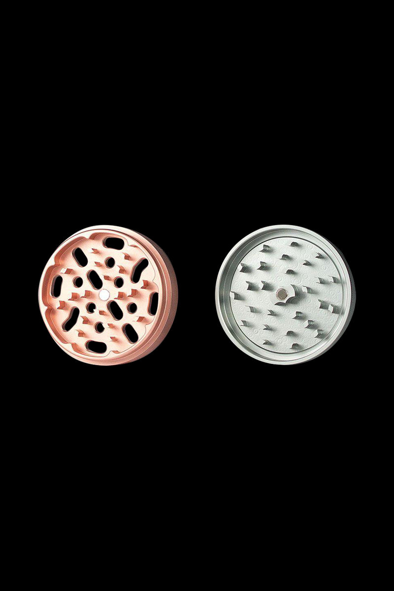 Close-up front view of the Kannastor 4-Piece Solid Body Grinder, displaying its circular metallic body with visible grinding teeth.