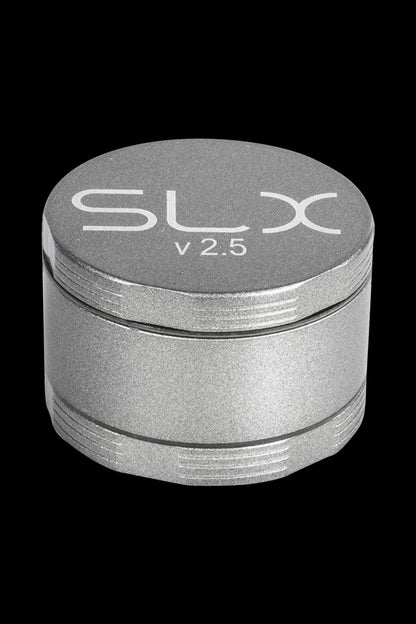 Front view of the SLX Ceramic Coated 2.5" Medium Grinder, showcasing its metallic finish and cylindrical shape.
