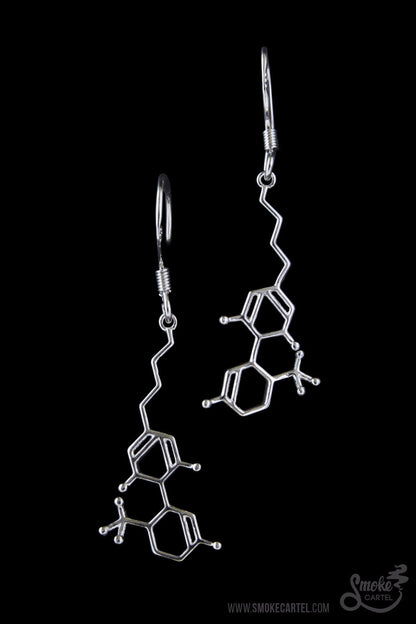 A detailed studio shot of the Smoke Cartel THC Molecule Earrings, showcasing the silver-toned, intricate molecular design.