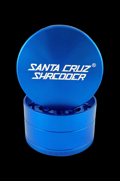 A front view of the Santa Cruz Shredder Grinder - Large, featuring a bright blue cylindrical shape.