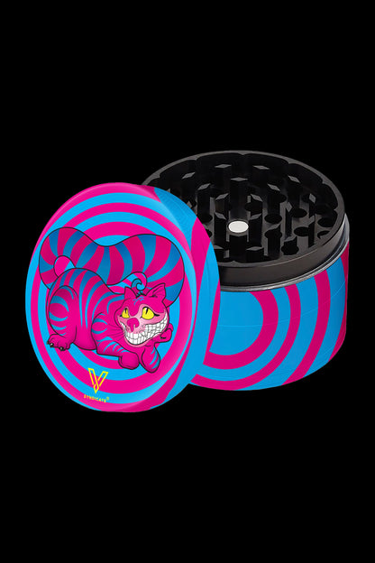 A vibrant pink and blue grinder featuring the Cheshire Cat from Alice in Wonderland, displayed open with its grinding teeth visible.