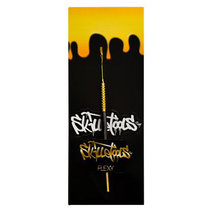 A close-up of the Skilletools Gold Series Dab Tools with a metallic gold finish, presented against a dark, reflective background.