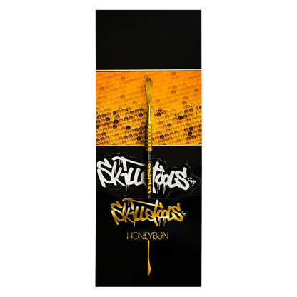 A close-up shot of the Skilletools Gold Series Dab Tools against a textured gold background.