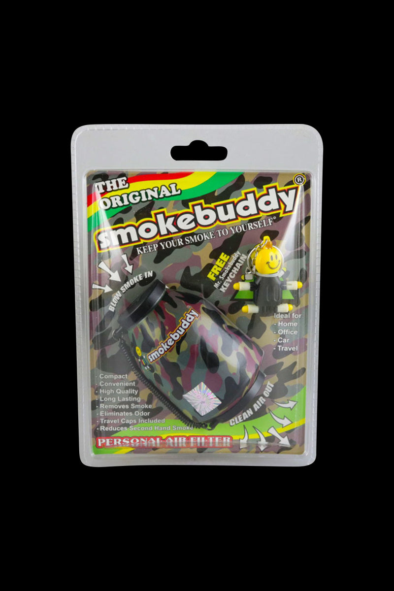 Front-facing shot of a green camo Smokebuddy Original Personal Air Filter in blister packaging against a black background.