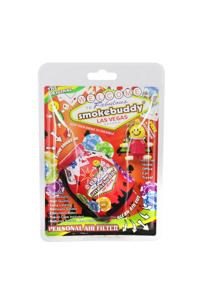 Front-facing shot of the brightly colored Smokebuddy Original Personal Air Filter blister pack with Las Vegas graphics and a small smiling keychain inside