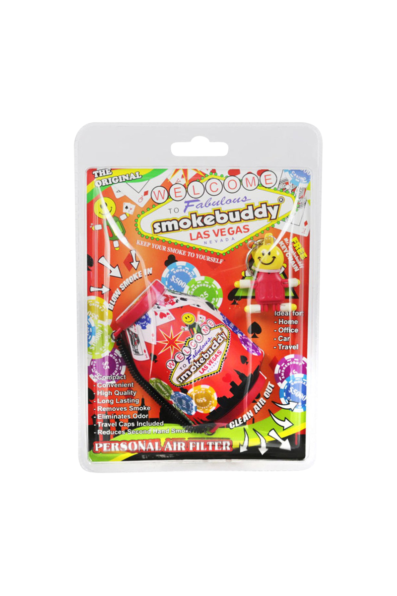 Front-facing shot of the brightly colored Smokebuddy Original Personal Air Filter blister pack with Las Vegas graphics and a small smiling keychain inside