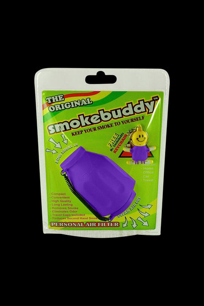 Front-facing shot of the Las Vegas purple Smokebuddy Original Personal Air Filter in its bright green blister pack against a black background.