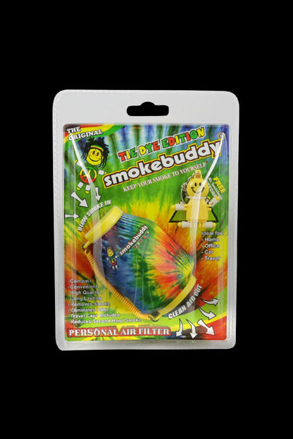 Front-facing shot of the tie-dye Smokebuddy Original Personal Air Filter in its blister pack against a black background.